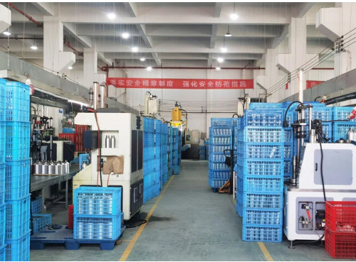 Industrial workshop with blue crates and machinery, organized manufacturing floor