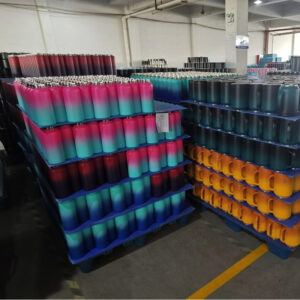 Colorful gradient bottles and mugs stacked, factory storage