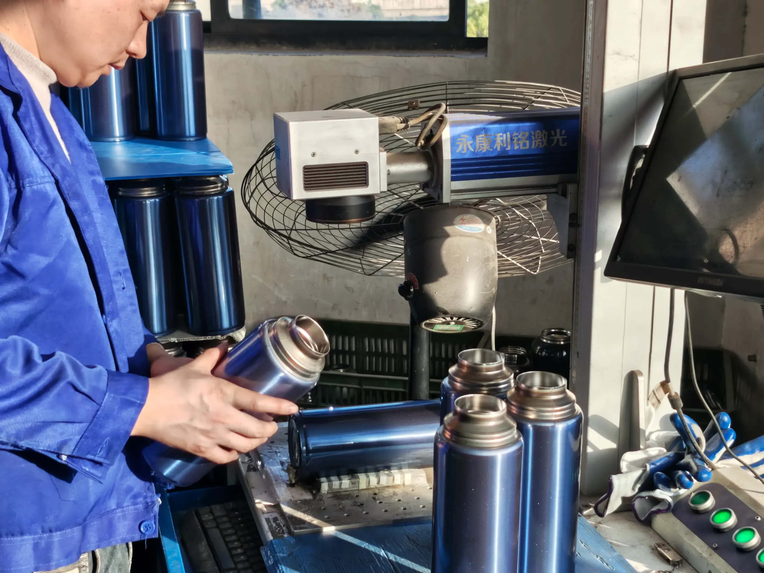 Bottle customization process Laser etching a logo on powder-coated steel water bottle